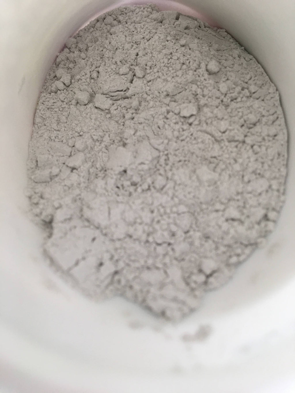 Close-up of pale rooting powder inside a container